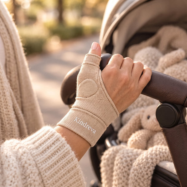 Hand wearing the Kindreva stabilizer gripping a stroller handle outdoors